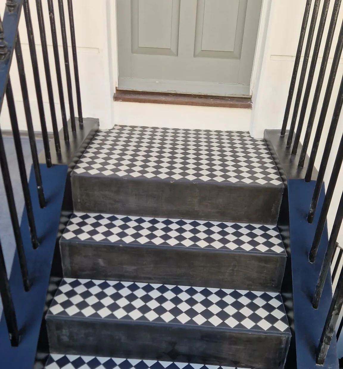 Front steps tiled in black and white Victorian chequerboard tiles